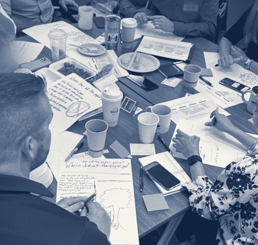 A team working through printed prompts around a table